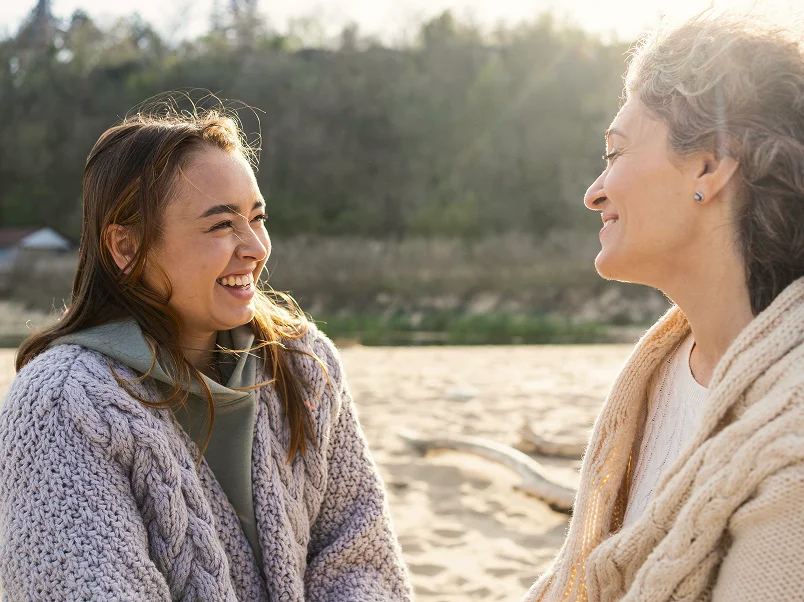 Two women talking on the beach